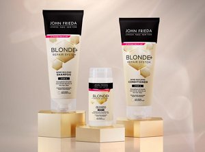John Frieda's Blonde+ Repair System products against a light gold background